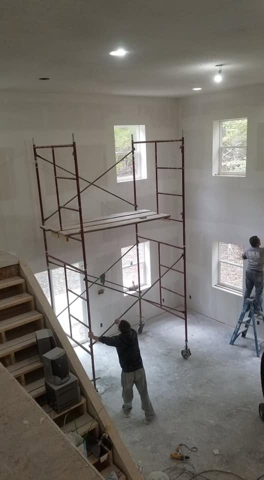 Drywall work — tall room on scaffolding