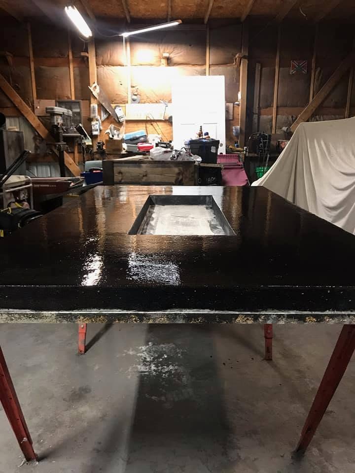 Black concrete fire table top in the shop