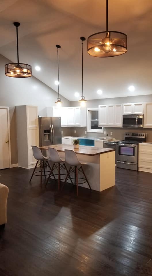 Kitchen — island, stove, pendant lights